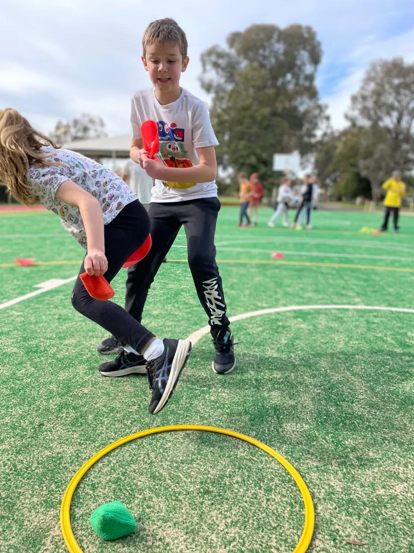 Children taking part in a throwing and movement challenge